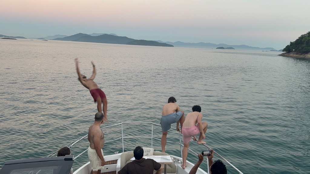 Jumping off the boat at sunset in Rio